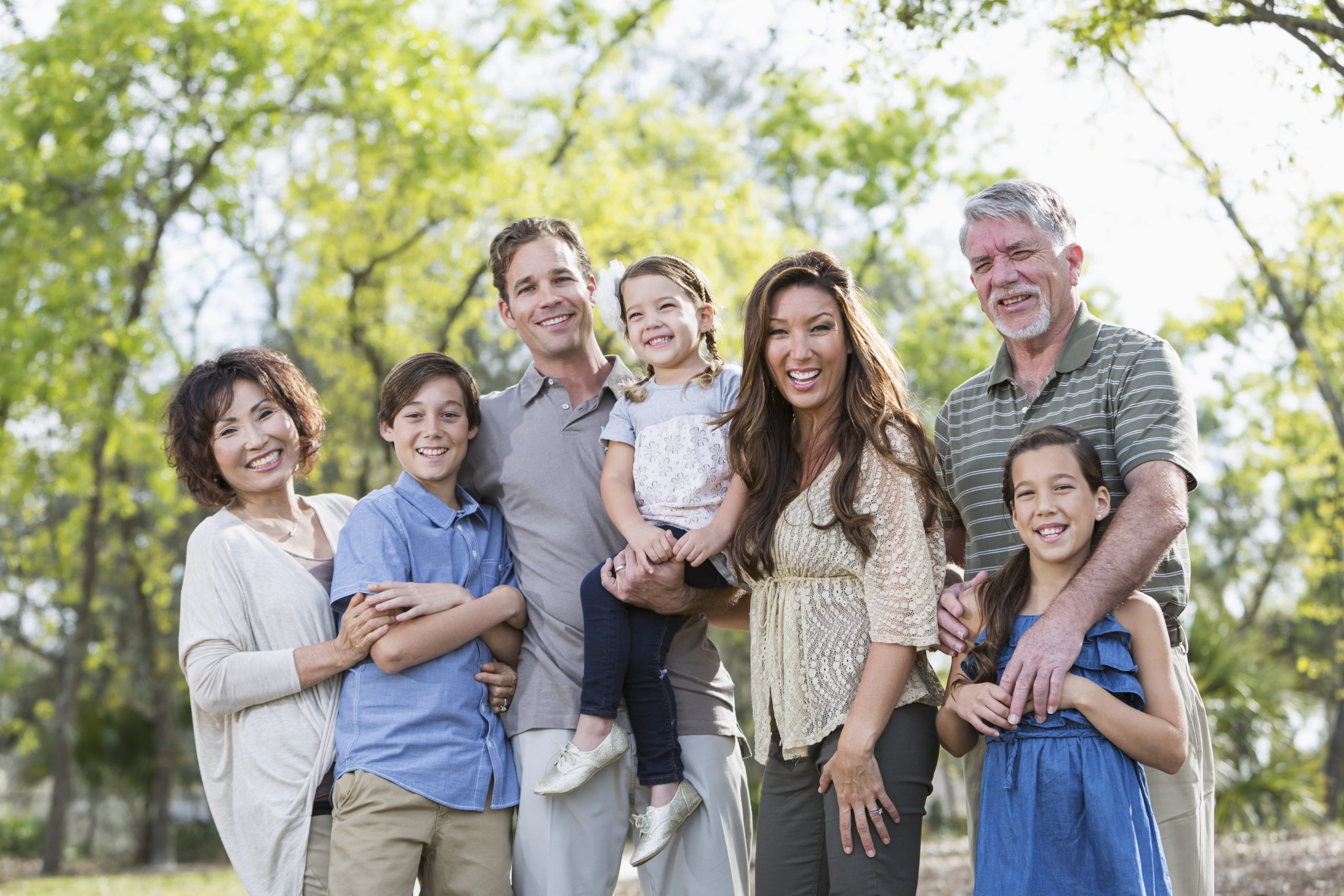 Multi-generation, mixed race family outside together